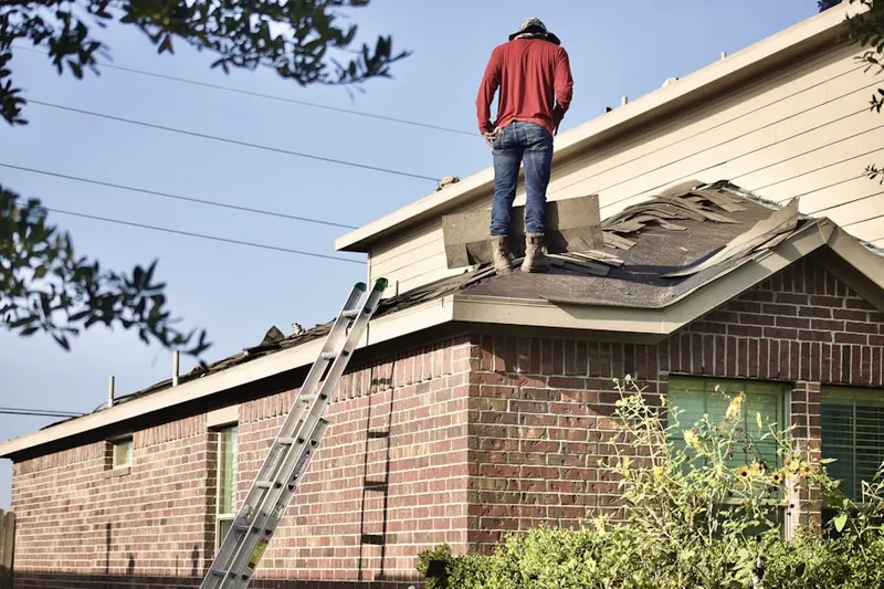 Professional roofer working on a residential roof in Grove Center